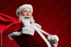 Fotografia Waist Up Portrait Of Smiling Santa Claus Holding Bag With Christmas Presents Ove